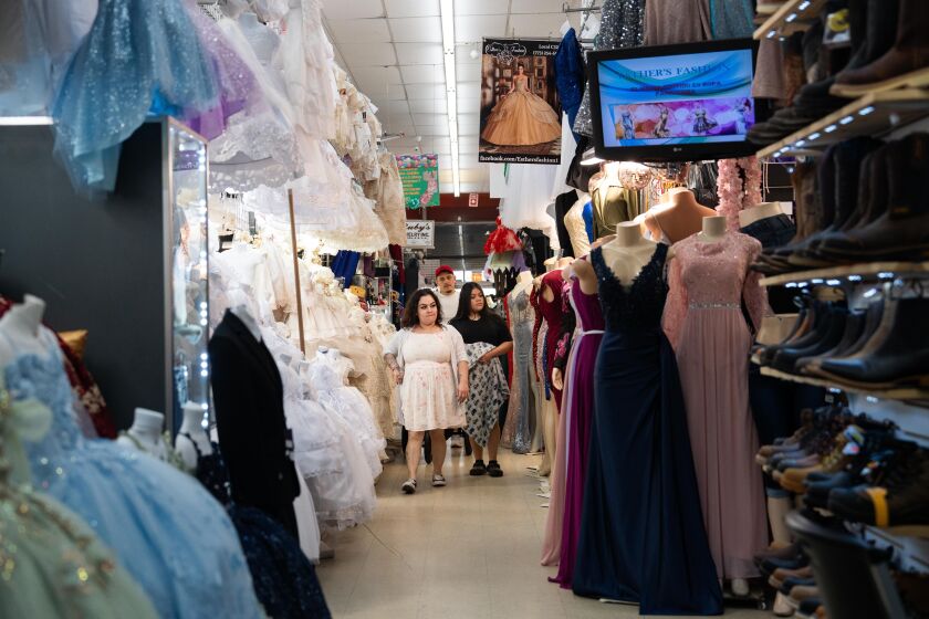 Shoppers walk around the Little Village Discount Mall.