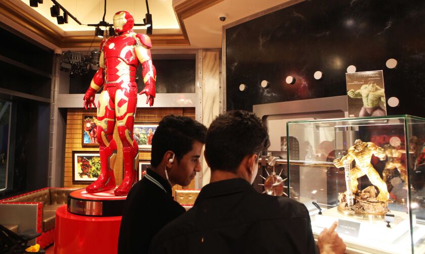 Two teenagers look at a statue of the Incredible Hulk that includes a fancy pen on sale at the IMG Worlds of Adventure amusement park in Dubai, United Arab Emirates, on Wednesday, Aug. 31, 2016. The Hulk pen set costs 114,940 dirhams, or $31,230. The life