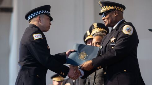 Chicago Police Supt. David Brown hands new police officer Alfonso Mercado a certificate during the graduation of Recruit Class 21-3 and 21-4 and promotion ceremony at the Aon Grand Ballroom in Navy Pier, Tuesday morning, March 29, 2022.