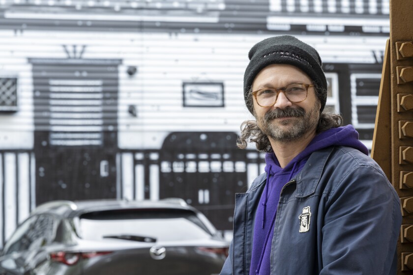 Muralist Nick Fisher painted the Logan Square building in the background.