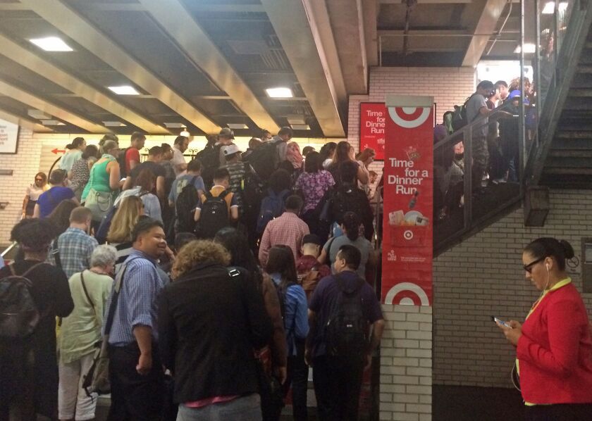 Commuters head up the steps to the train platform after service resumed at the CTA’s Belmont station. | Emily Moon/For the Sun-Times