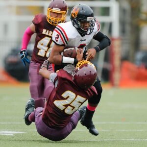 Marine’s Isaac Thorton (25) takes down Phoenix’s Jamon Gooden (2).