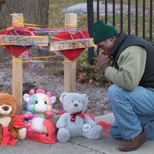 Ziff Sistrunk places crosses outside of Mercy Hospital Tuesday. | Scott Olson/Getty Images