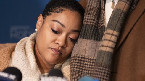 Mercedes Wells, whose baby was delivered by her husband Leon Wells after she was discharged by Franciscan Health Crown Point in Indiana despite being in labor, leans on her husband during a news conference at the Lester Long Fieldhouse in Dolton, Ill., Tuesday, Nov. 25, 2025.