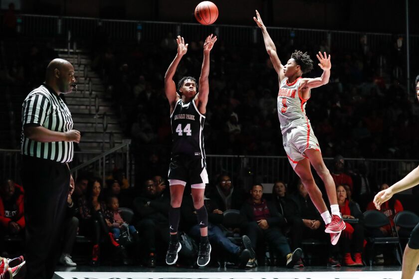 Morgan Park’s Adam Miller (44) shoots the ball past Bogan’s Antione Bloxton (3).