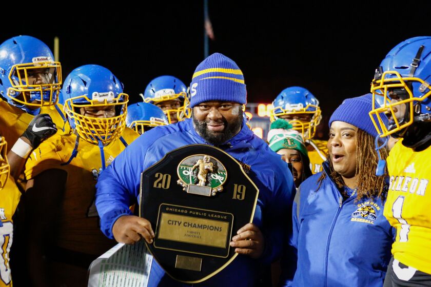 Dante Culbreath holds the 2019 City Champions plaque after beating Morgan Park.
