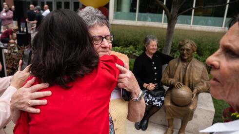 Margaret Mary hugs Sister Jean Dolores Schmidt’s niece after an unveiling ceremony for Schmidt’s statue at Loyola University Chicago in Rogers Park.