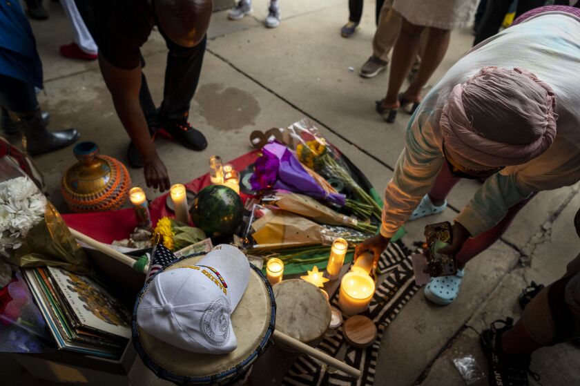 A memorial was set up Friday, July 16, 2021 at Kimbark Plaza for Keith Cooper, who died after he was punched in the head during an attempted carjacking in the plaza earlier in the week.