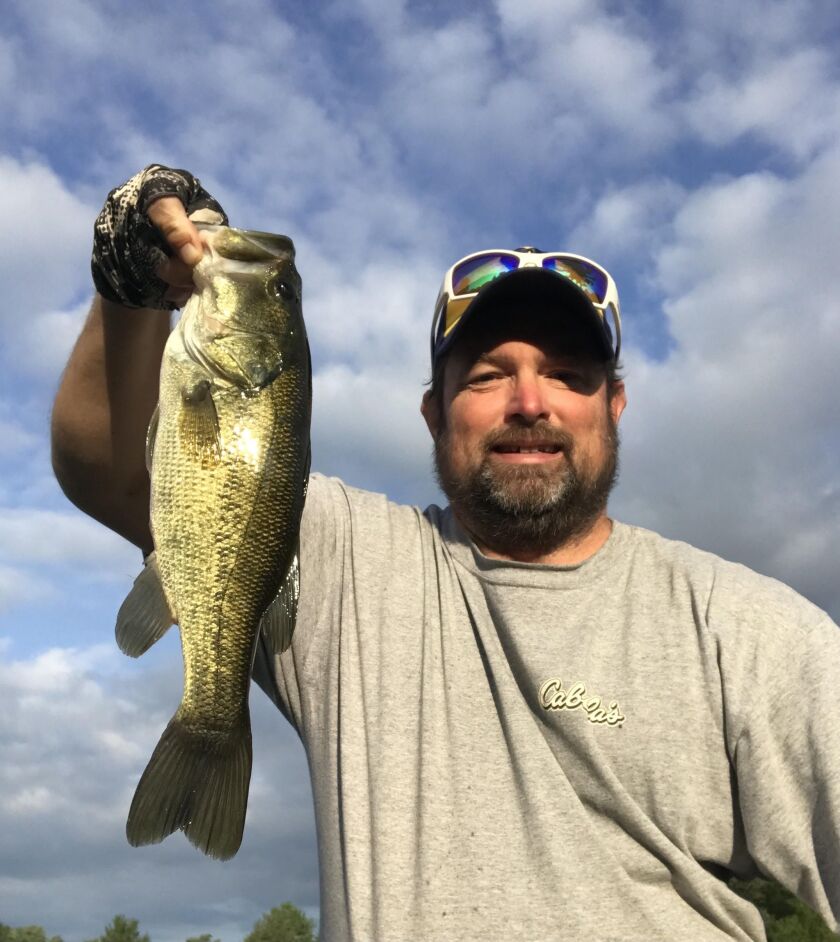 Ken “Husker” O’Malley with a local, late-summer largemouth bass. Provided photo