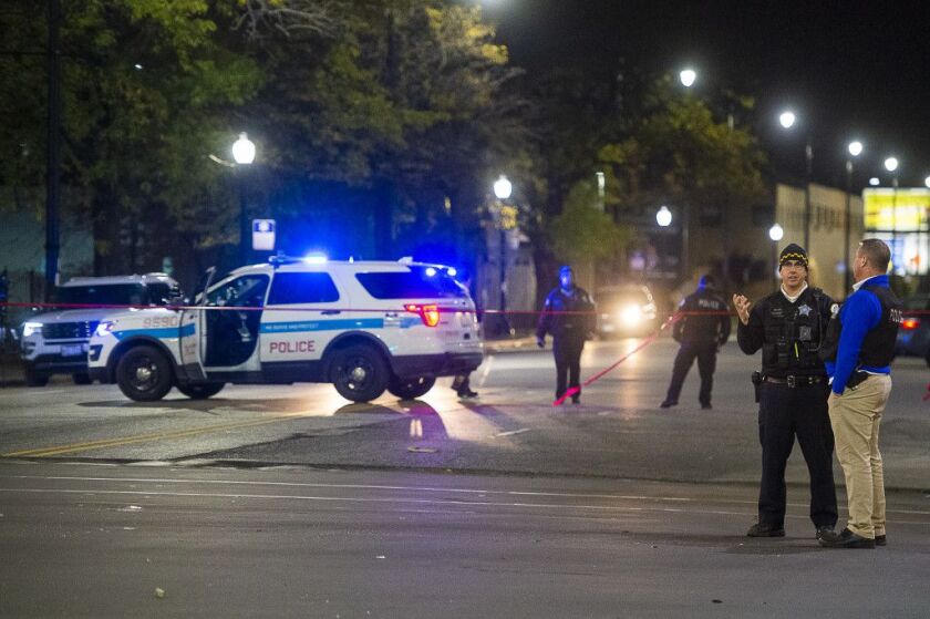 Police investigate the scene of a fatal hit-and-run, Tuesday morning in the 7900 block of South Cottage Grove. The victim was stuck on 79th and Cottage Grove and his body was dragged to 79th and Dobson. | Tyler LaRiviere/Sun-Times