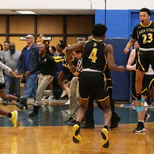 Marian Catholic’s bench celebrates as the Spartans defeat next-door neighbor Bloom.