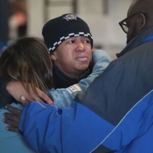 Police officers embrace at the Wentworth District police station Tuesday. | Scott Olson/Getty Images