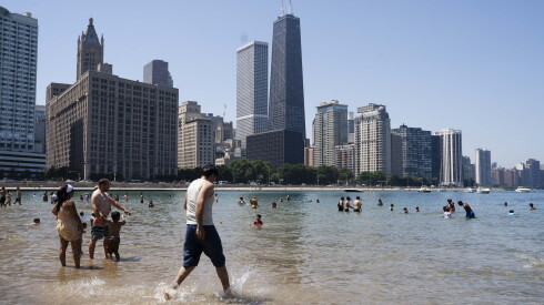 Beachgoers take a dip in Lake Michigan at Ohio Street Beach as temperatures soared, Tuesday, July 14, 2026.