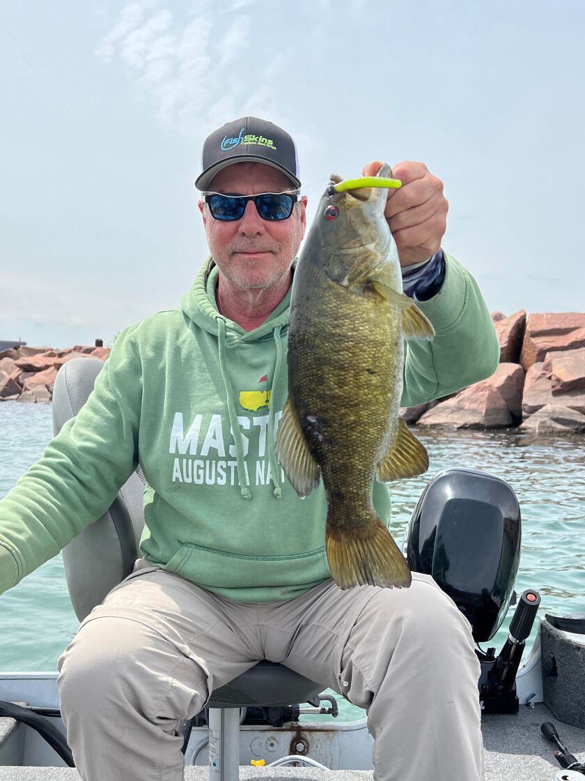 Dale Rehus with a good smallmouth bass from the Indiana waters of southern Lake Michigan. Provided by James Baranski