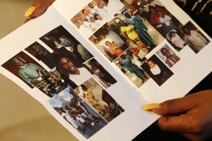 Alexis Willis holds the funeral program for her cousin Jaheim Wilson, who was shot and killed as he walked with a friend in Chicago. Willis has joined a group at her school that advocates peace but worries about her own safety. “I don’t want to die this s