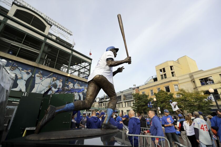 <em>Billy Williams’ statue is seen as fans arrive at Wrigley Field before Game 3 of the World Series between the Cubs and the Indians (AP).</em>