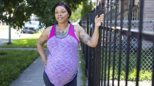 Shantis Johnson, who is pregnant with twins, poses outside her Austin home.