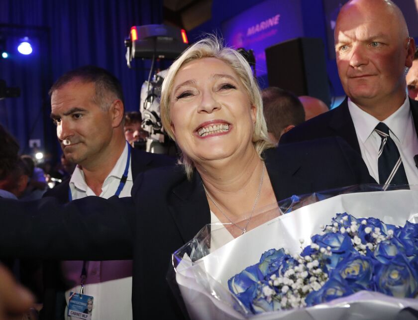 Far-right leader and candidate for the 2017 French presidential election, Marine Le Pen, surrounded by bodyguards, celebrates with supporters after exit poll results of the first round of the presidential election were announced at her election headquarte