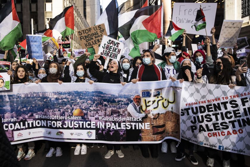 Demonstrators hold up a banner for the Coalition for Justice in Palestine during a march through the Loop, May 12, 2021. The coalition is an umbrella organization for a number of Chicago-chapter pro-Palestine groups.