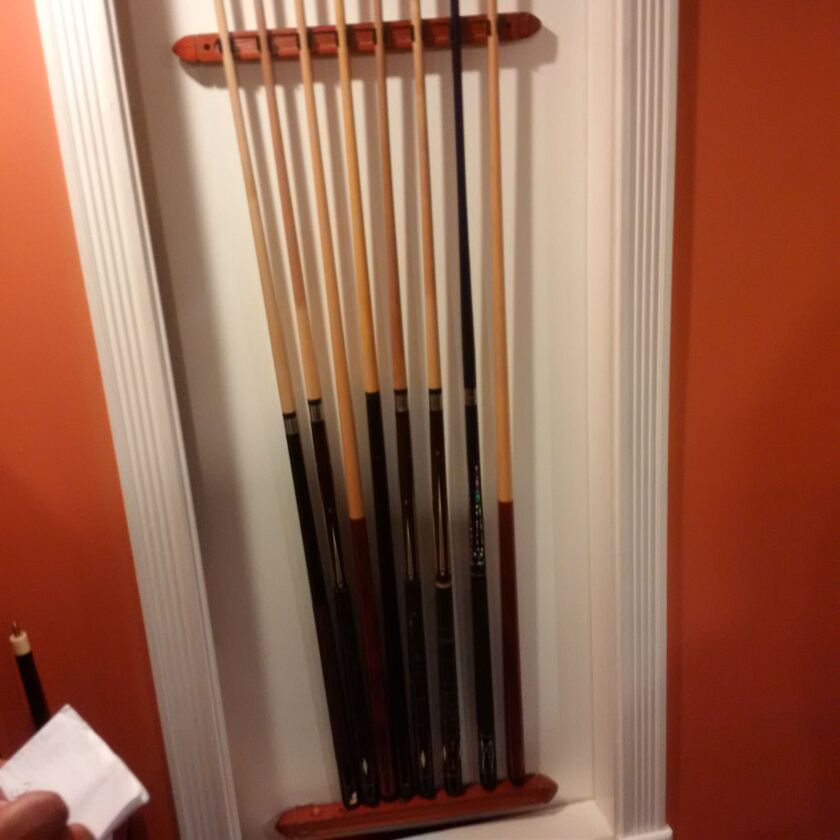 Behind the this rack of pool cues in the basement of a Belmont Cragin home, Chicago Police executing a serach warrant found a secret room (below) filled with a stash of drugs, money and guns. | Chicago Police
