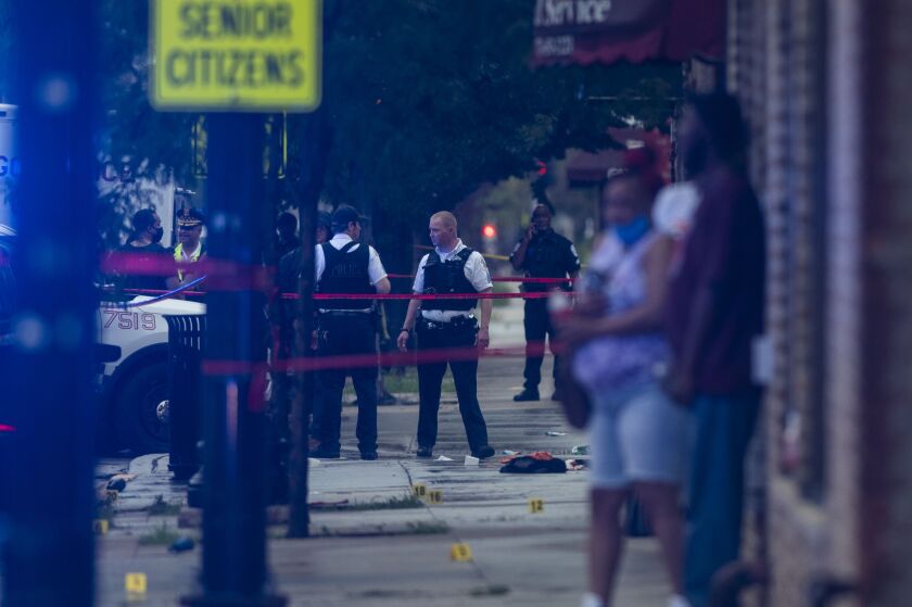 Chicago police investigate the scene of a mass shooting after more then a dozen people were shot in the 7900 block of South Carpenter in the Gresham neighborhood on the South Side, Tuesday night, July 21, 2020.