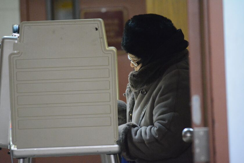 A woman votes in the 7th ward in 2015.