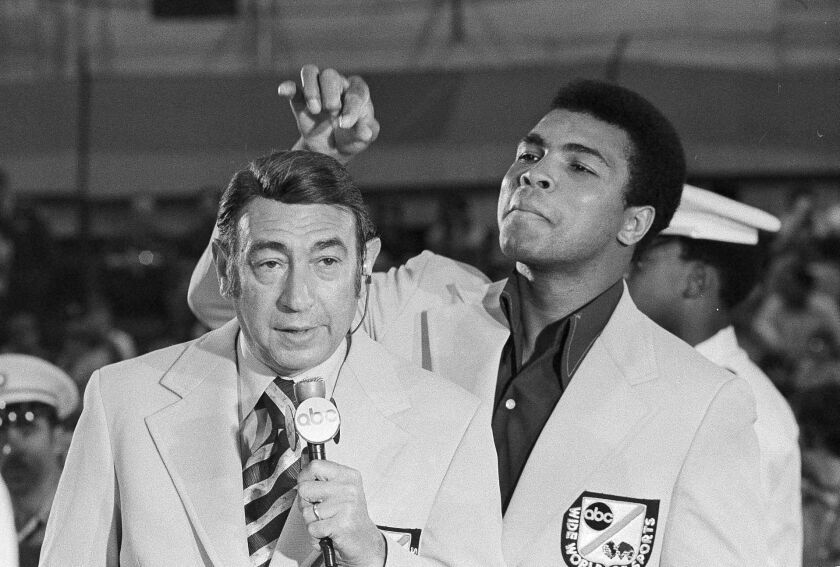 In this Aug. 7, 1972, file photo, Muhammad Ali jokes with television sports commentator Howard Cosell before the start of the Olympic boxing trials, in West Point, New York. | AP