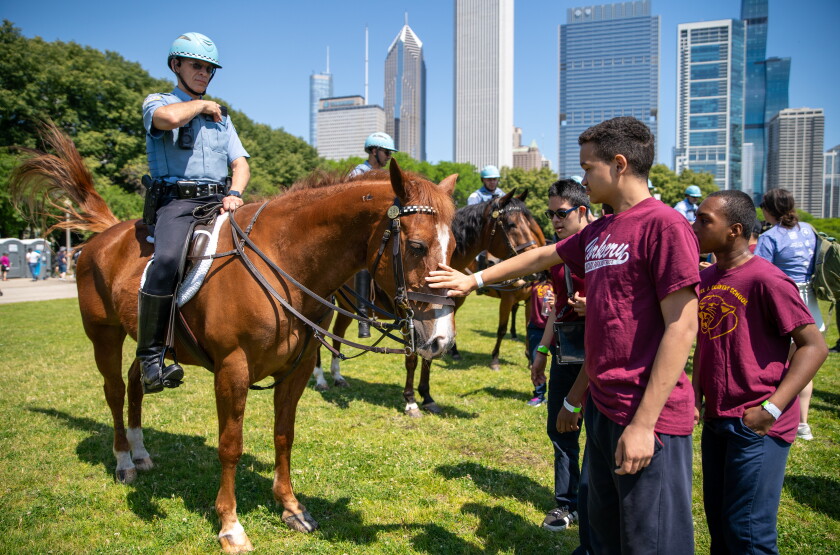 Students pet a Chicago Police Department horse at the All-Star Fest.