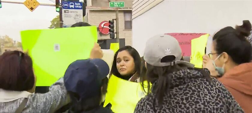 Ald. Julia Ramirez is confronted by protesters Thursday over plans for a tent city in her ward.