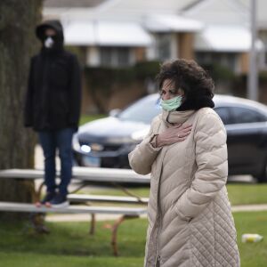 Family and friends of Chicago Police Officer Marco DiFranco stand outside Cumberland Funeral Chapels during the funeral amid fears of the coronavirus pandemic, Thursday, April 9, 2020
