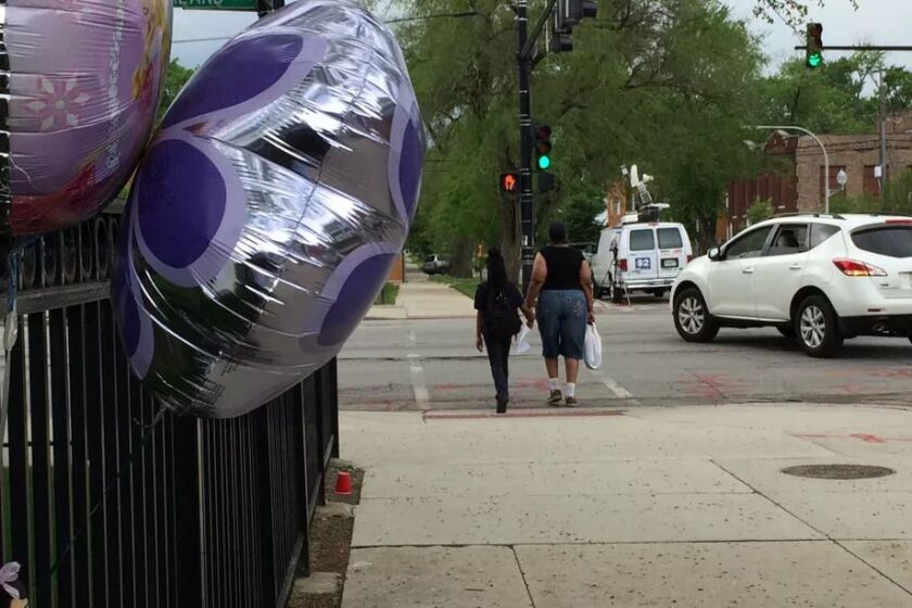 Balloons adorn fence outside Providence Englewood Charter School in May 2016 after Samyra Lee was struck and killed while trying to cross Ashland Avenue near the school.