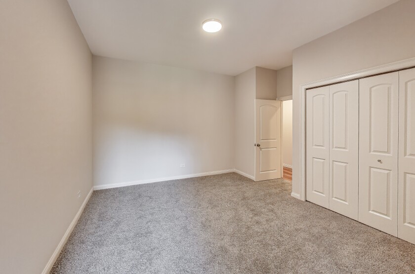 One of the bedrooms with carpeting