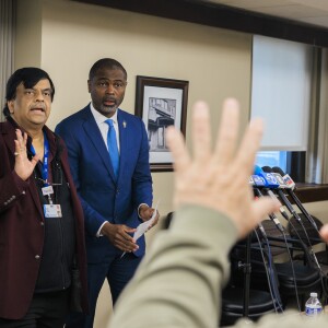 A reporter puts his hands up Wednesday as he asks questions to Resilience Healthcare CEO Manoj Prasad and State Rep. La Shawn K. Ford about the future of West Suburban Medical Center in Oak Park.