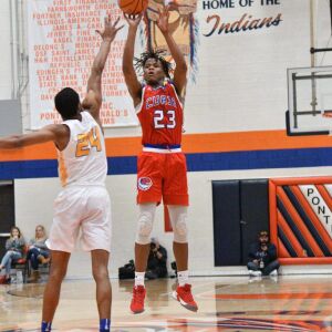 Curie’s Ramean Hinton (23) pulls off a three point shot, Saturday 12-29-18. Worsom Robinson/For Sun-Times