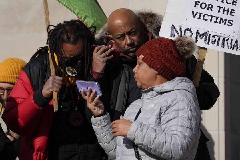 Justin Blake, left, uncle of Jacob Blake, listens to the verdict being read outside the Kenosha County Courthouse, Friday, Nov. 19, 2021 in Kenosha, Wis. Kyle Rittenhouse was acquitted of all charges after pleading self-defense in the deadly Kenosha shootings that became a flashpoint in the nation’s debate over guns, vigilantism and racial injustice.