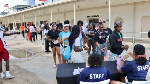 Youth wait in line ahead of an August beach party.