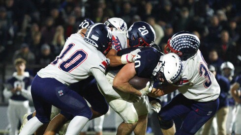 Cary-Grove's Logan Abrams (40) is wrapped up by Belvidere North’s defense.