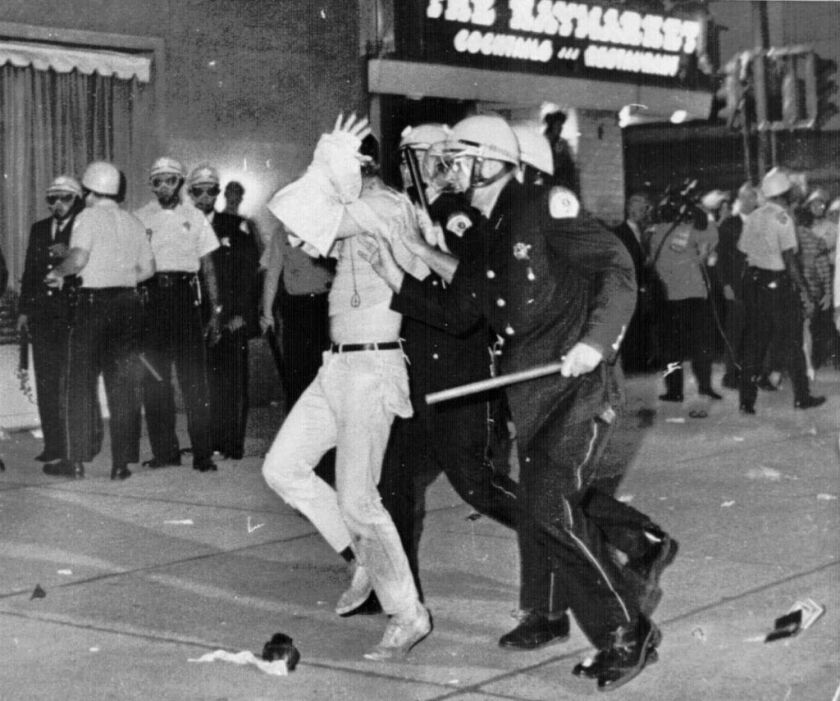 On Aug. 28, 1968, a demonstrator with his hands on his head is led by Chicago police officers down Michigan Avenue during a confrontation with police and National Guardsmen who battled protesters near the Conrad Hilton Hotel, headquarters for the Democrat
