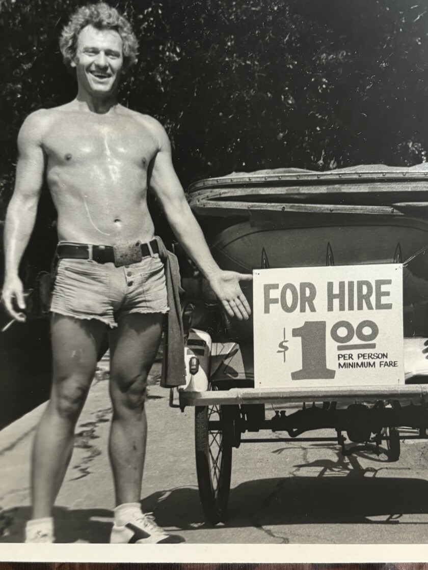 Ron Dean standing next to his pedicab