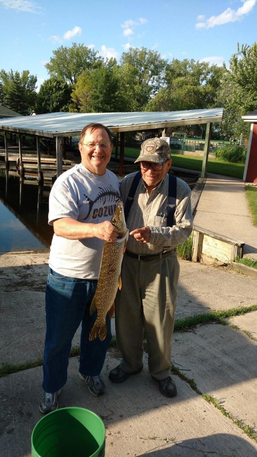 Casey Bloom and his brother Larry holding a Northern pike.