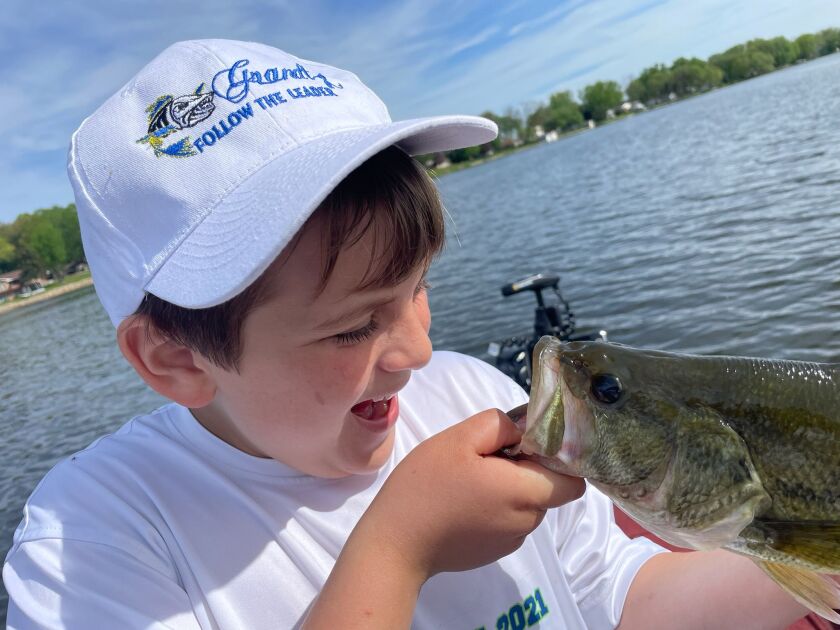 Matthew Hauser from South Elgin going face to face with a Fox Lake largemouth bass in Wisconsin. Provided by Mike Norris