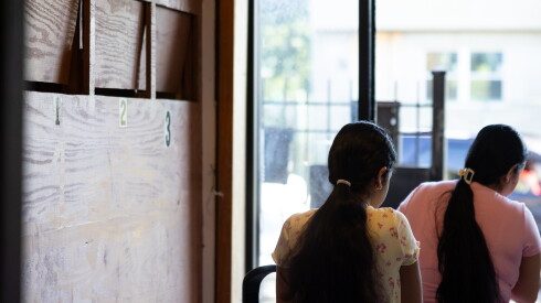Carolina, an immigrant from Venezuela, leaves her West Side apartment building with her family for her immigration court hearing on Thursday.
