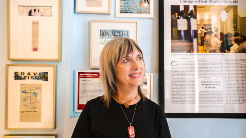 Lisa Santos, owner of Southport Grocery and Cafe, in front of culinary awards and newspaper features. The restaurant will close Dec. 31 and will be replaced by a Dollop Finer Diner in the new year.