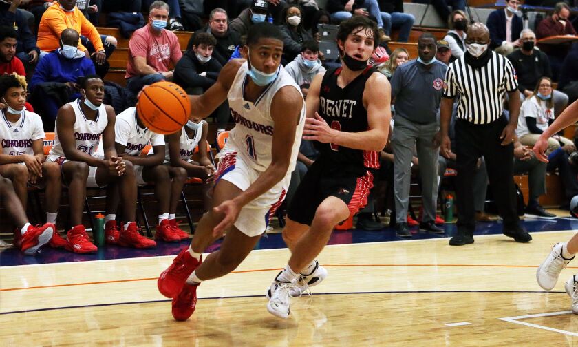 Curie’s Phoenix Bullock (1) drives toward the basket as the Condors play Benet, Pontiac, Illinois, December 30, 2021.