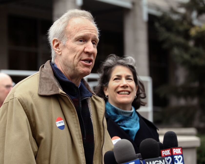 Gov. Bruce Rauner talks to reporters after voting at the Divine Mercy Parish Center in Winnetka in 2018 as his wife, Diana looks on.