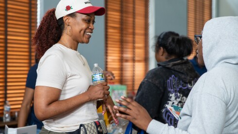 Doula Zetanefert Zipewtu helps a guest at the Black Maternal Health Week Baby Shower at the Garfield Park Fieldhouse on Saturday.
