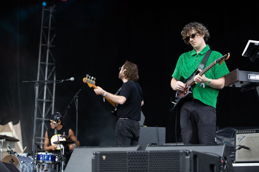 Deeper guitarist Mike Clawson plays at the Green Stage at Pitchfork.