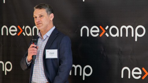 Nexamp CEO Zaid Ashai speaks into a microphone.