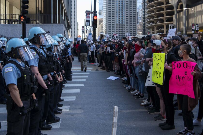 Protesters squad off with Chicago police on Kinzie and State Street, during a protest for George Floyd, Saturday, May 30, 2020. 