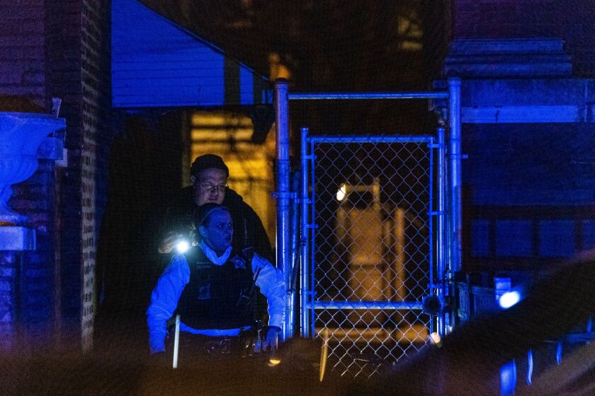 Chicago Police investigate the scene where a man was shot, Saturday night, in the 6200 block of South Rhodes, in the West Woodlawn neighborhood. | Tyler LaRiviere/Sun-Times